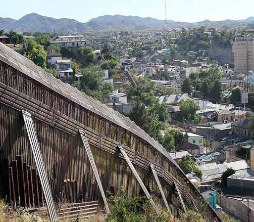 NOGALES, AZ - JUNE 02: A fence separates the cities of Nogales, Arizona and Nogales, Sonora Mexico, a frequent crossing point for people entering the United States illegally, June 2, 2010 in Nogales, Arizona. During the 2009 fiscal year 540,865 undocumented immigrants were apprehended entering the United States illegally along the Mexican border, 241,000 of those were captured in the 262 mile stretch of the border known as the Tucson Sector. (Photo by Scott Olson/Getty Images)