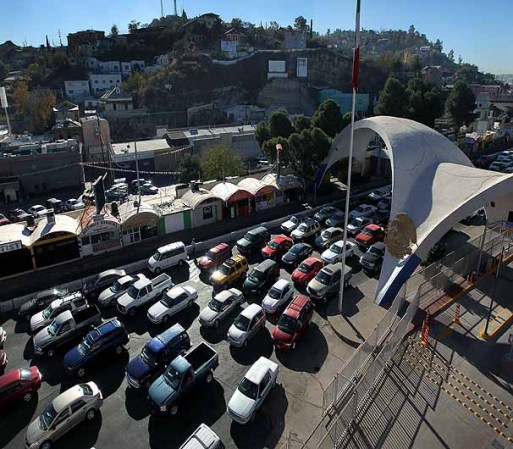 NOGALES, AZ - DECEMBER 10: Hundreds of cars wait to pass from Mexico into the United States at the border crossing on December 10, 2010 in Nogales, Arizona. Despite Arizona's tough immigration enforcement laws, thousands of Mexican citizens have permits to work in the U.S. and commute daily from their homes across the border in Mexico. Border crossings, known as "ports of entry," are run by the U.S. Office of Field Operations, which is part of the department of U.S. Customs and Border Protection. Port personnel are the face at the border for most visitors and cargo entering the United States and are authorized to stop, question, search and examine everyone entering the country. (Photo by John Moore/Getty Images)