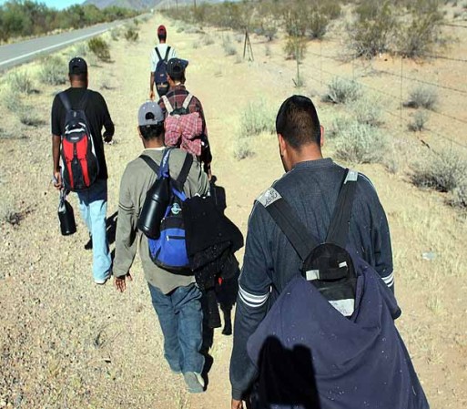 TOHONO O'ODHAM NATION, AZ - JANUARY 19: Undocumented Mexican immigrants walk through the Sonoran Desert after illegally crossing the U.S.-Mexico border border on January 19, 2011 into the Tohono O'odham Nation, Arizona. The immigrants said they had wandered the desert lost for a week after crossing from Mexico into the vast Indian reservation at night. Exhausted, they requested the Border Patrol to pick them up and take them to the U.S.-Mexico border, from where they would return to their homes in the Mexican state of Sonora. They had come, they said, to reach Phoenix and find work in construction or landscaping. All said they had worked in Arizona before. (Photo by John Moore/Getty Images)