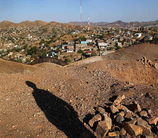 NOGALES, AZ - JUNE 22: A U.S. Army National Guardsman overwatches the U.S.-Mexico border on June 22, 2011 in Nogales, Arizona. The Pentagon recently extended the deployment of some 1,200 guardsmen who were deployed last year to assist with border security on the U.S.-Mexico border until September 30. Soldiers at Early Identification Team (EIT) observation posts in Nogales work 24 hour shifts, each taking turns resting for 4 hours during the night. The National Guard troops are strictly on surveillance duty, although they are armed and have been credited with helping U.S. Border Patrol agents arrest up to 17,000 illegal immigrants crossing into the United States. (Photo by John Moore/Getty Images)