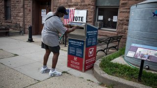 Voter drops off ballot