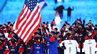 Flag bearers Brittany Bowe and John Shuster of Team USA lead the team during the Opening Ceremony of the Beijing 2022 Winter Olympics at the Beijing National Stadium on Feb. 4, 2022 in Beijing, China.