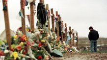 Ryan Foreman of Denver's South Metro Fire Department, visits a memorial for the victims of Columbine High School tragedy in Clement Park April 30, 1999.