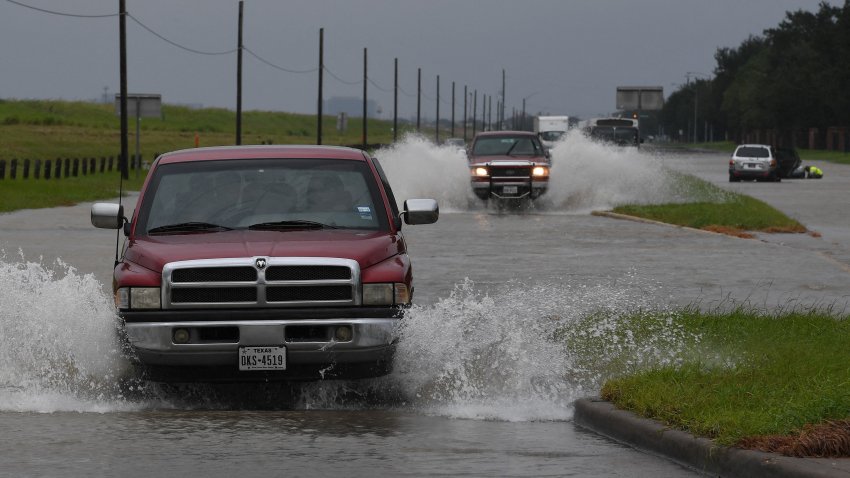 TOPSHOT – Vehicles drive along a flooded road beside the Barker Reservoir after the Army Corp of Engineers started to release water into the Clodine district as Hurricane Harvey caused heavy flooding in Houston, Texas on August 29, 2017.  Hurricane – Harvey has set what forecasters believe is a new rainfall record for the continental US, officials said Tuesday. Harvey, swirling for the past few days off Texas and Louisiana has dumped more than 49 inches (124.5 centimeters) of rain on the region. (Photo by MARK RALSTON / AFP) (Photo by MARK RALSTON/AFP via Getty Images)