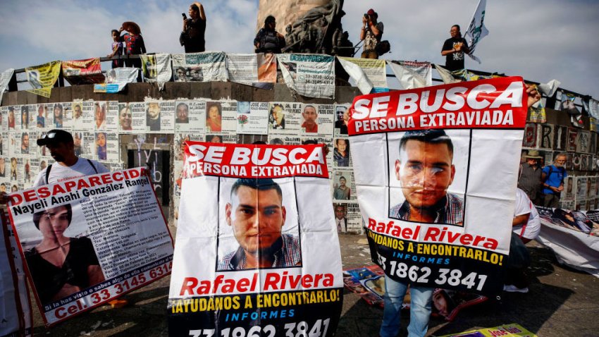 TOPSHOT – Relatives of missing persons hold signs with photos of their loved ones during a march against the government’s ban on searches for the disappeared, which was implemented after an attack on prosecutors during one of the searches in recent days, in Guadalajara, Jalisco State, Mexico, on July 16, 2023. According to the latest official report published in May by the Mexican government, more than 100,000 people have disappeared in Mexico, and more than 15,000 are from the state of Jalisco. (Photo by ULISES RUIZ / AFP) (Photo by ULISES RUIZ/AFP via Getty Images)