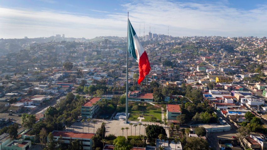 TIJUANA, MEXICO – MARCH 06: In an aerial view, an enormous Mexican flag flies near the far western end of the U.S.-Mexico border on March 06, 2024 in Tijuana, Mexico. The border between the two nations stretches nearly 2,000 miles, from the Gulf of Mexico to the Pacific Ocean and is marked by fences, deserts, mountains and a river that runs through most of it. The politics and controversies surrounding border and immigration issues have become dominant themes in the U.S. presidential election campaign. (Photo by John Moore/Getty Images)