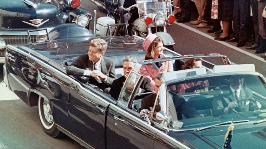 US President John F Kennedy, First Lady Jacqueline Kennedy, Texas Governor John Connally, and others smile at the crowds lining their motorcade route in Dallas, Texas, on November 22, 1963. Minutes later the President was assassinated as his car passed through Dealey Plaza.