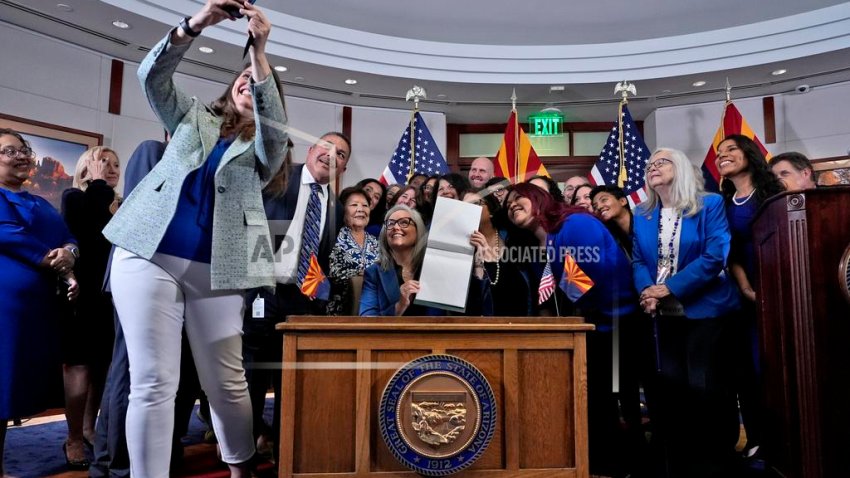 FILE – Arizona Rep. Stephanie Stahl Hamilton takes a selfie with Arizona Gov. Katie Hobbs after Hobbs signed the repeal of the Civil War-era near-total abortion ban on May 2, 2024, at the state Capitol in Phoenix. (AP Photo/Matt York, File)