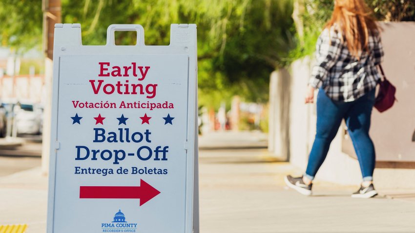 People walk to cast their ballot during early voting in the US presidential election at Recorder’s Main Offic, in Tucson, Arizona, on October 16 2024. (Photo by Olivier Touron / AFP) (Photo by OLIVIER TOURON/AFP via Getty Images)