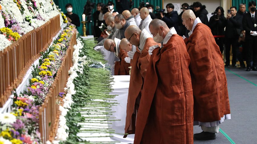 MUAN-GUN, SOUTH KOREA – DECEMBER 30: South Korean monks pay tribute at a group memorial altar for victims of Flight 7C2216 at the Muan sport park December 30, 2024 in Muan-gun, South Korea. A plane carrying 181 people, Jeju Air Flight 7C2216, crashed at Muan International Airport in South Korea after skidding off the runway and colliding with a wall, resulting in an explosion. According to reports, 179 were killed in the crash. (Photo by Chung Sung-Jun/Getty Images)