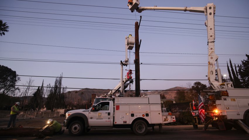 FILE – Southern California Edison workers service a utility pole in the aftermath of the Eaton Fire, Jan. 12, 2025, in Altadena, Calif. (AP Photo/Ethan Swope, file)