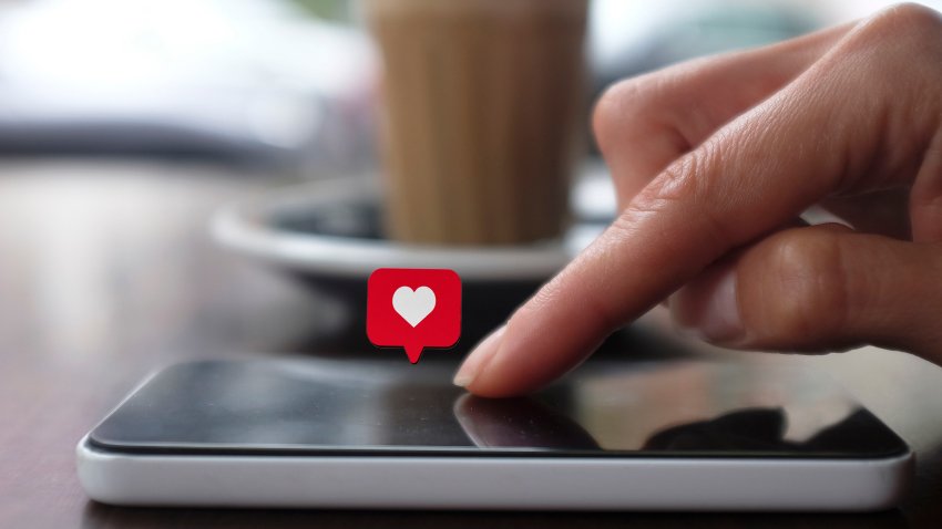 Young woman using smart phone with social media symbols