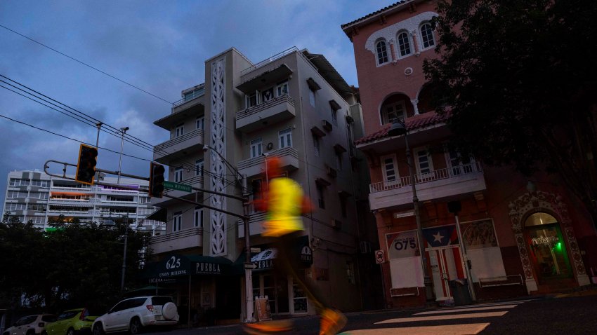 A man jogs on a dark street in San Juan, Puerto Rico after a major power outage hit the island on December 31, 2024. A major power outage plunged much of Puerto Rico into darkness Tuesday, with the US island territory’s electric utility saying restoration could take up to two days. The “island-wide blackout” began at 5:30 am (0930 GMT), Luma Energy said in a social media statement. (Photo by Ricardo ARDUENGO / AFP) (Photo by RICARDO ARDUENGO/AFP via Getty Images)