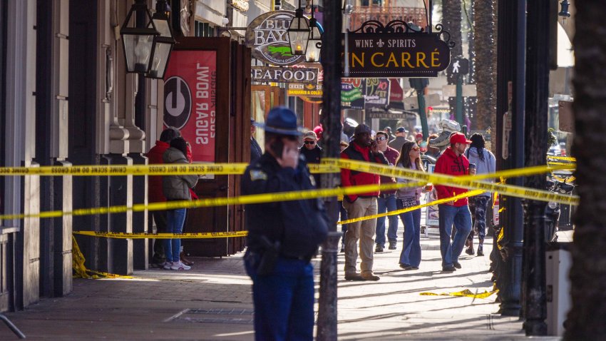 NEW ORLEANS, LOUISIANA – JANUARY 2, 2025: Officers stand at Bourbon Street, as pedestrians walk down Canal Street where a man drove a pickup truck into a crowd of people in the French Quarter of New Orleans on early new years day. (Photo by Kathleen Flynn for the Washington Post)