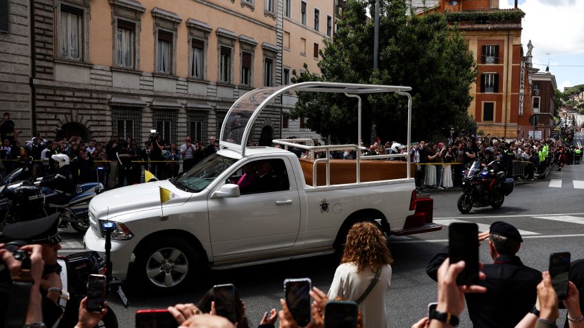 Well-wishers take pictures with their mobile phone of the coffin of late Pope Francis as it is transported on a popemobile from St Peter’s Basilica to Santa Maria Maggiore Basilica, during the funeral ceremony in Rome on April 26, 2025. (Photo by HENRY NICHOLLS / AFP) (Photo by HENRY NICHOLLS/AFP via Getty Images)