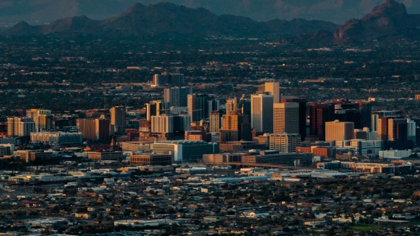 PHOENIX, ARIZONA – JULY 15: In an aerial view, the downtown skyline is seen during a heat wave on July 15, 2023 in Phoenix, Arizona. Weather forecasts today are expecting temperatures to reach 115 degrees. The Phoenix area is grappling with record-breaking temperatures as prolonged heat waves continue soaring across the Southwest. (Photo by Brandon Bell/Getty Images)