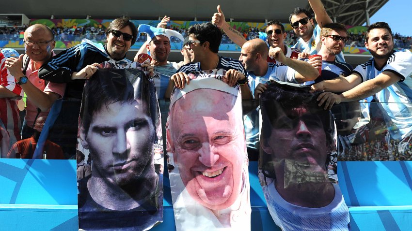 SAO PAULO, BRAZIL – JULY 01: Argentina fans display posters of Lionel Messi, Pope Francis and Diego Maradona during the 2014 FIFA World Cup Brazil Round of 16 match between Argentina and Switzerland at Arena de Sao Paulo on July 01, 2014 in Sao Paulo, Brazil.  (Photo by Chris Brunskill Ltd/Getty Images)