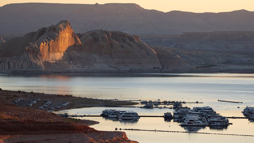 PAGE, ARIZONA – JULY 10: The sun rises over Wahweap Marina on Lake Powell in Glen Canyon National Recreation Area on July 10, 2025 in Page, Arizona. Lake Powell, a critical Colorado River reservoir, is only at a third of its capacity as drought conditions in the Southwest worsen. (Photo by Rebecca Noble/Getty Images)